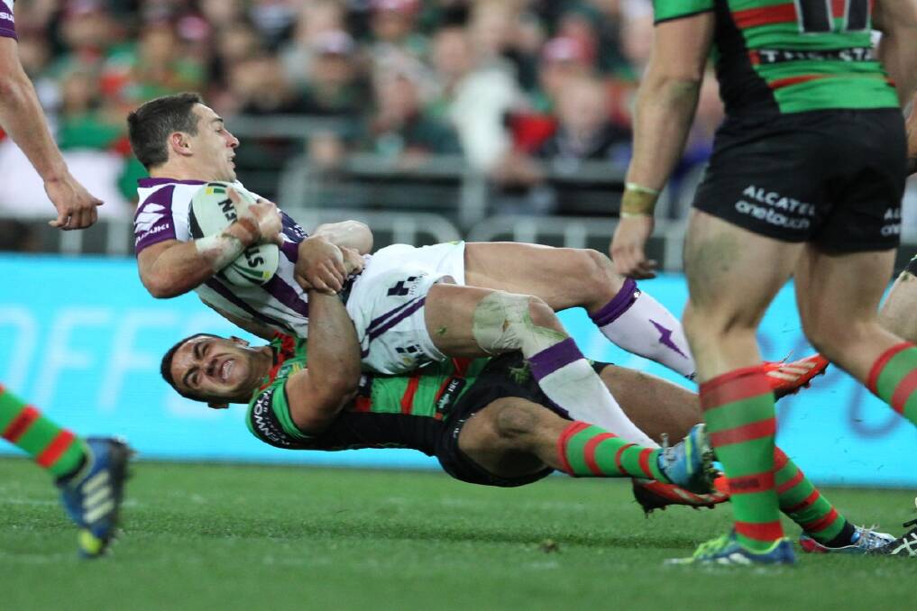 Billy Slater gets tackled during the South Sydney Rabbitohs vs Melbourne Storm game at ANZ Stadium on Friday 13th September, 2013. Photo: Anthony Johnson 