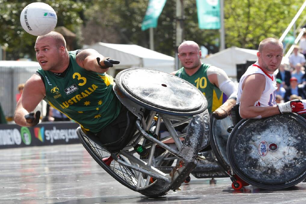 Ryley Batt (AUS) looks to offload during the Wheelchair Rugby Tri-Nations at St Mary's Cathedral Square between USA v Australia. Photo: Dallas Kilponen 