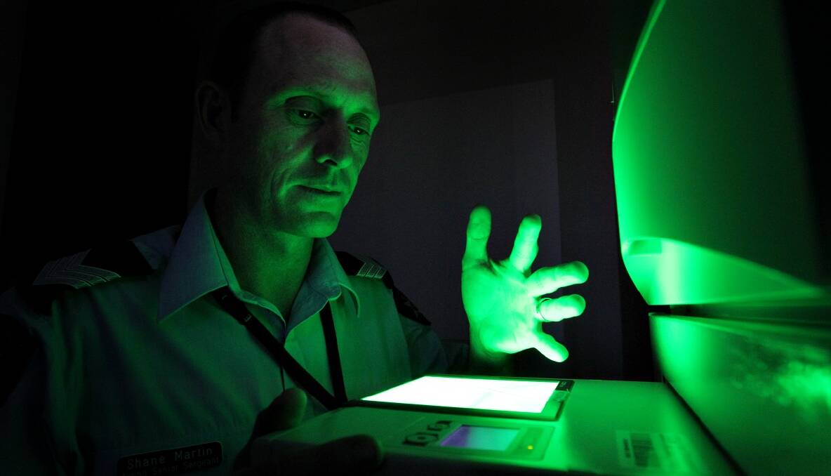 Acting Sen-Sgt Shane Martin with the Live Scan fingerprinting machine, now available for name and record checks in Wodonga. Picture: DAVID THORPE
