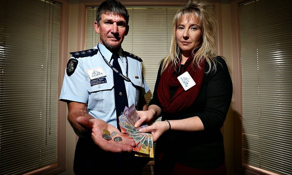  Inspector David Ryan and Angelique Phillips, Manager Operations for NESAY hold out $201.35. PICTURE: John Russell.