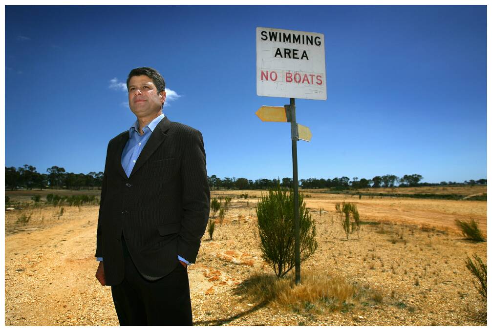 Then premier Steve Bracks stands in Lake Eppalock, which was at 3 per cent capacity, in November 2006. Picture: Craig Abraham