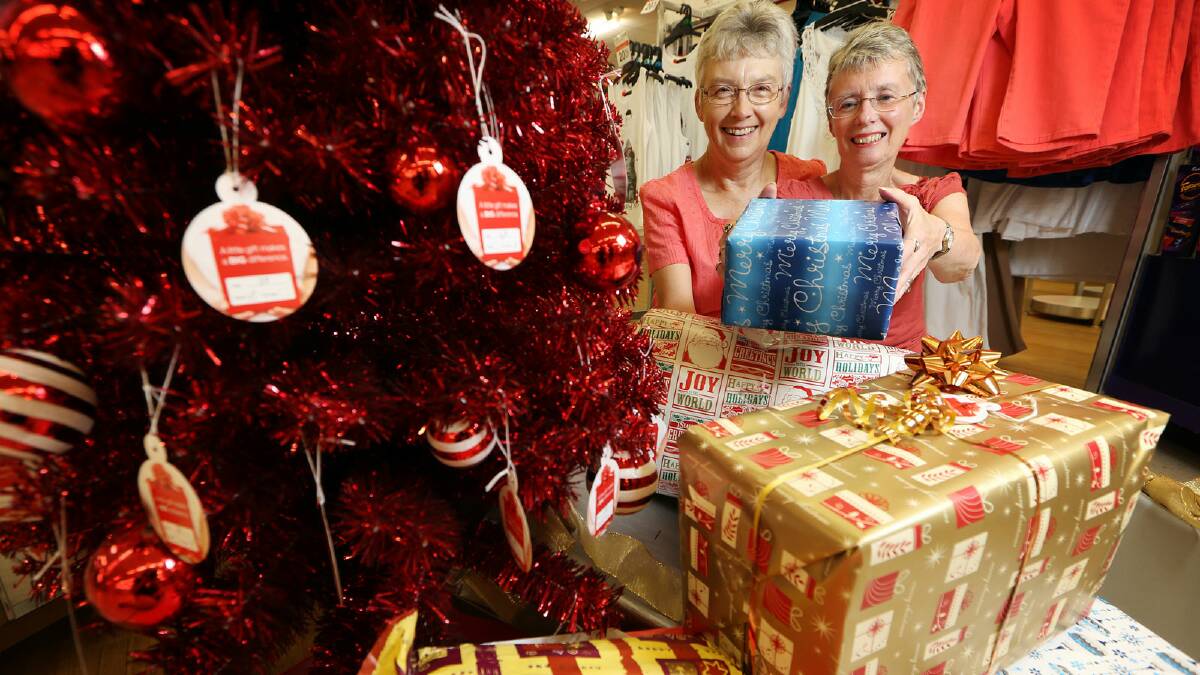 UnitingCare volunteers Carolyn Renfrey and Louanne Stabb with the Operation Santa Christmas tree. Picture:KYLIE ESLER