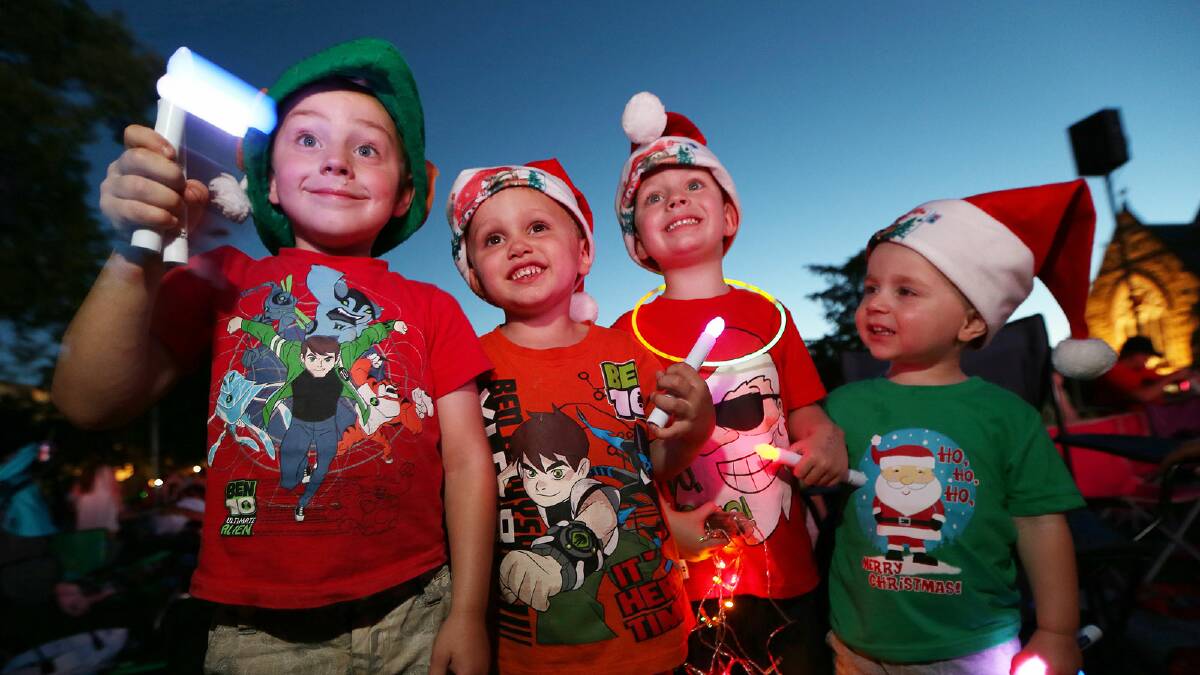 Zavier Hays, 4, Seth Booth, 3, Thomas Wells, 3, and Hugh Wells, 2, enjoy Albury’s Carols by Candlelight last night.  Pictures: JOHN RUSSELL