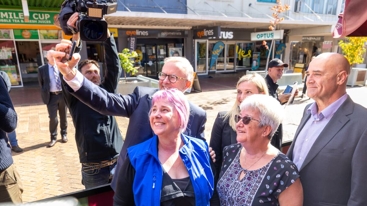 Labor leader Anthony Albanese and Labor canidate for Braddon Chris Lynch take a selfie with healthcare workers at a Devonport cafe on Monday. Picture: Sitthixay Ditthavong