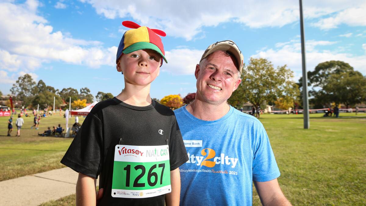 FAMILY AFFAIR: Lachlan, 8, with his father Luke Pearce, competed in the Half-Can and Ironman events respectively.