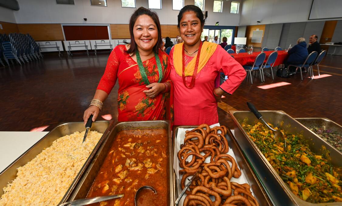 CULTURE CELEBRATION: Ganga McNamara and Kamail Bhujel serving up their Bhutanese cuisine at Mirambeena Community Centre. Picture: MARK JESSER