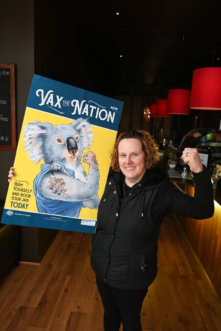 GET THE JAB: Helen McFarlane, manager of Coffee Mamma Wodonga, put the poster up in her store. Picture: MARK JESSER