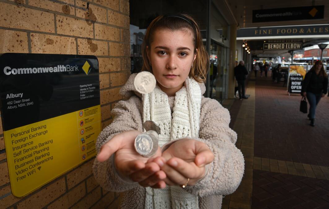 CHANGE UP: Phillipa Boglari-Davykoza ended up losing a slice of her savings when she took her coins to the Commonwealth Bank. Picture: MARK JESSER