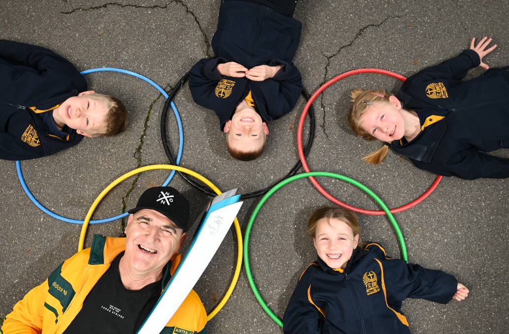 IN THE RINGS: Two time Olympian Pat Scammell in Jindera with St Johns Lutheran School students Benjamin Lustig, 5, Thomas Hancock, 6, Lily Knight, 5 and Emily Proos, 5. Pictures: MARK JESSER