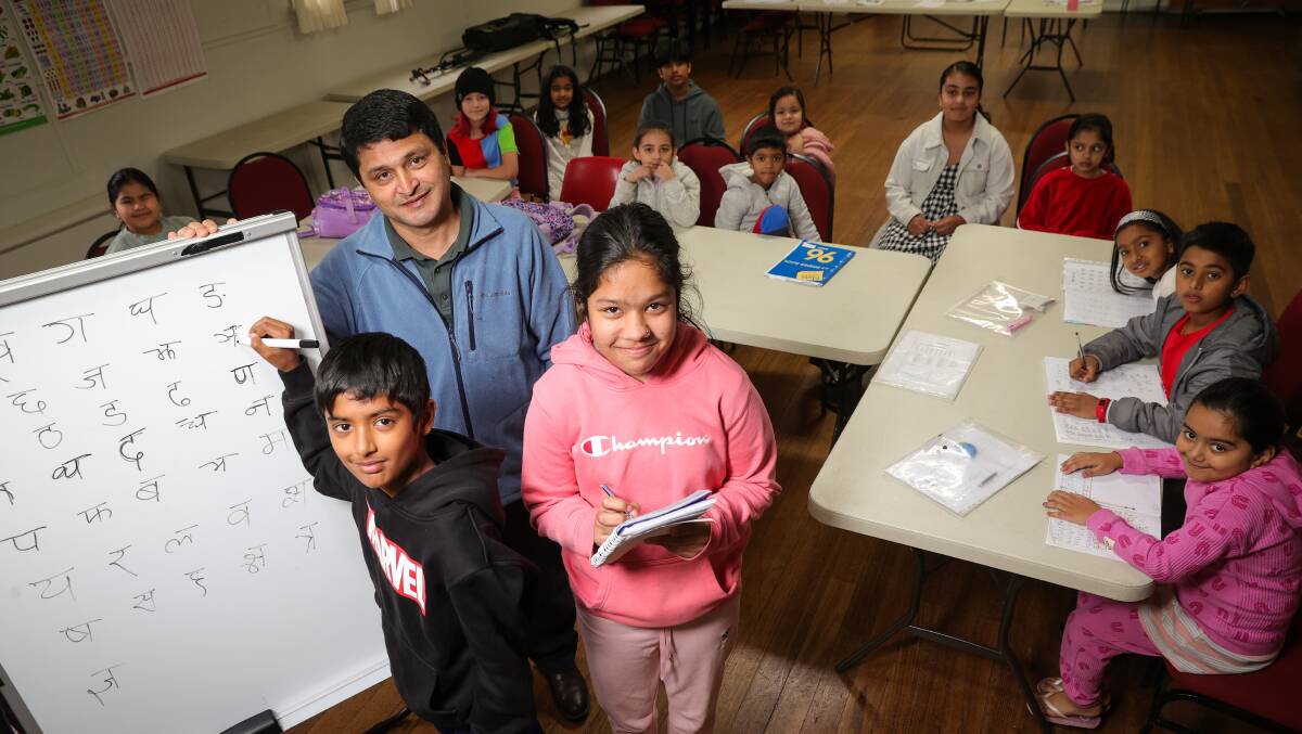 LEARNING: Teacher Harka Bista with Rowan Rimal, 10, Rowena Rimal, 11, at the Nepalese language class held in Lavington on Sundays. Picture: JAMES WILTSHIRE