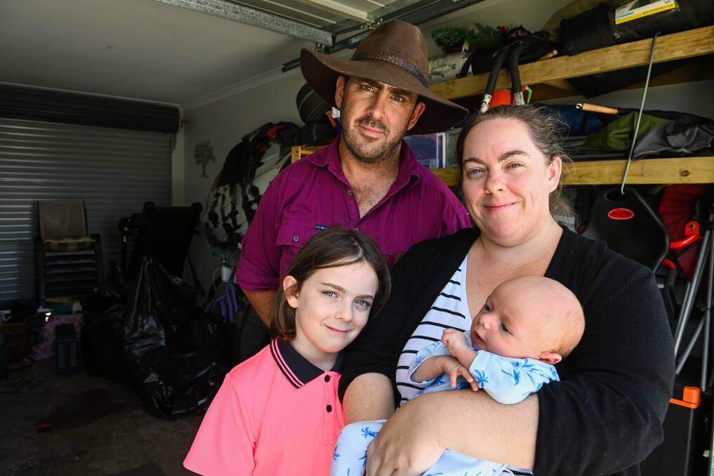 Brian and Natasha Raybould with their children Charlette, 8, and Layne, 7 weeks. Son Colby was not at home when their house flooded. Pictures: MARK JESSER