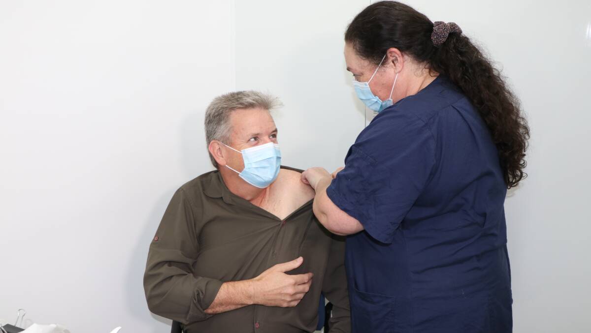 VACCINE TIME: Wodonga Paramedic Patrick Gleeson getting his first dose of the AstraZeneca vaccine at the Albury Wodonga Health covid-19 vaccination centre on Wednesday. Mr Gleeson said he's "pleased" to get his first shot.