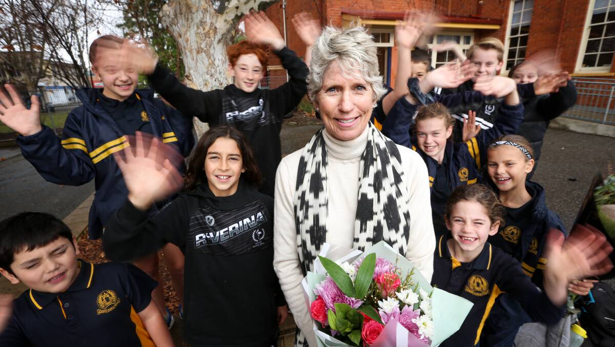 FAREWELL AND GOODLUCK: Albury Public School students wave goodbye to long serving teacher Lynn Macleod on her last day. Picture: JAMES WILTSHIRE