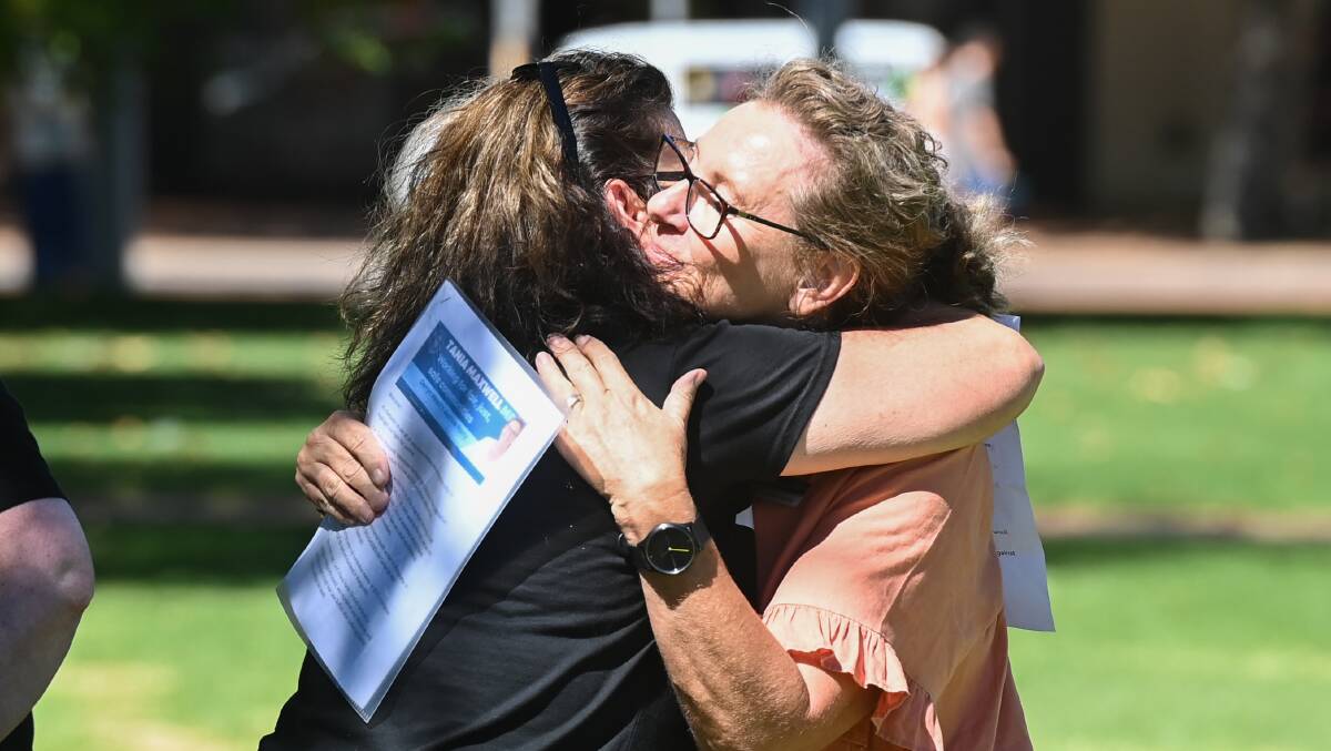 EMOTIONAL MOMENT: Activist Liz Marmo hugs Victorian MP Tania Maxwell after her speech at Albury's March 4 Justice gathering on Sunday. Picture: MARK JESSER