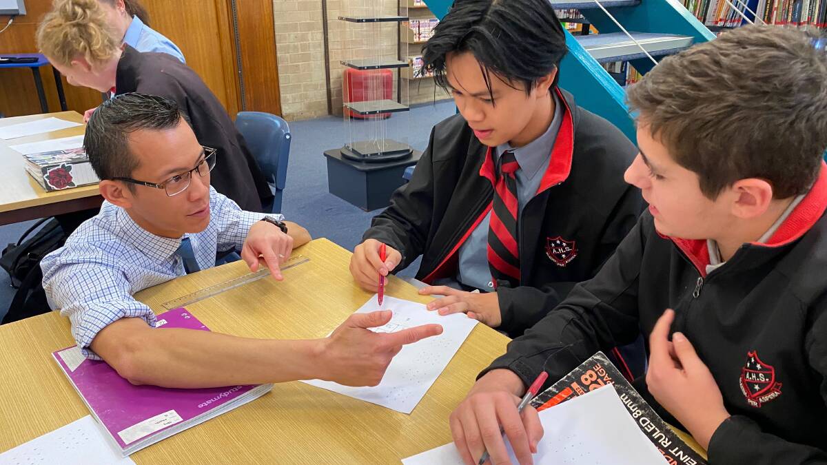 IMPARTING KNOWLEDGE: 2018 Local Hero and Australia's best known maths teacher Eddie Woo with Albury High school Year 10 students Aldron Rivera and Ryan Yensch.