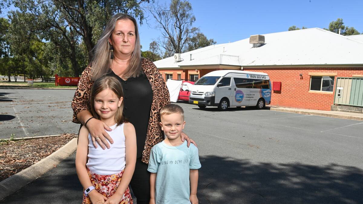 OVERWHELMED: Pippa Maddocks with her children Harper, 7, and Cian, 4 in front of the Thurgoona GoodStart Early Learning Centre which is temporarily closed. Picture: MARK JESSER