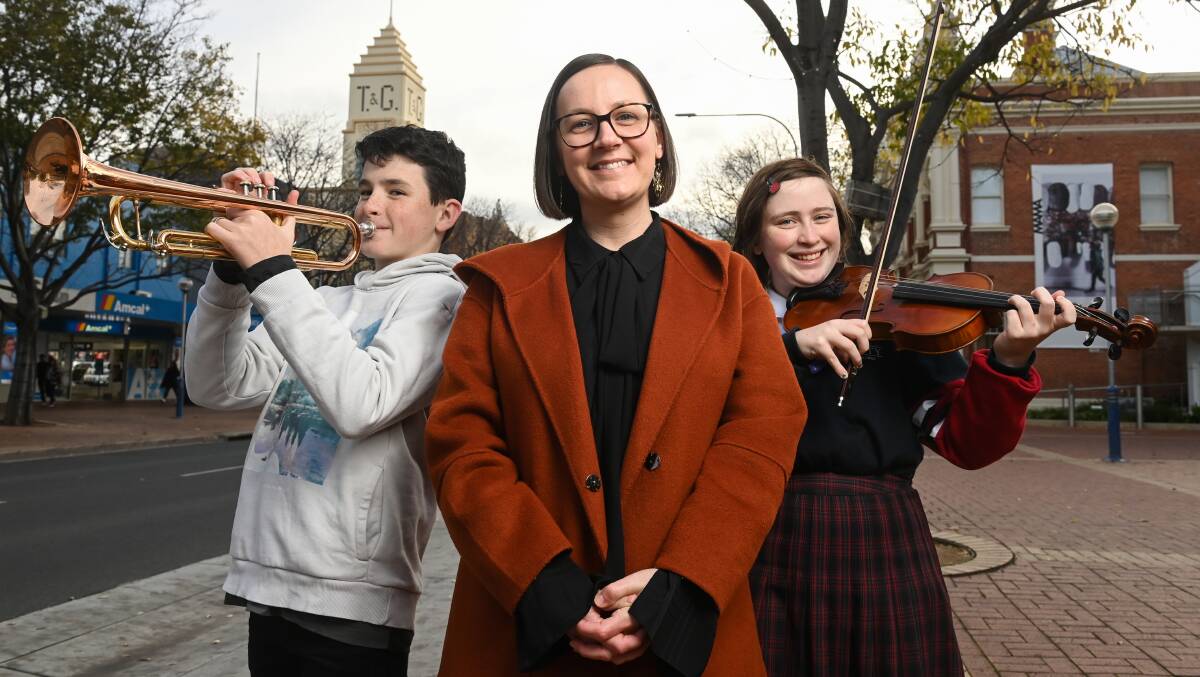 EAGER TO RETURN: Billy Stewart, 13, and Erin Swann, 17, and Border Music Camp chairperson Katie Clarke have welcomed the opening of applications to the holiday program. Picture: MARK JESSER