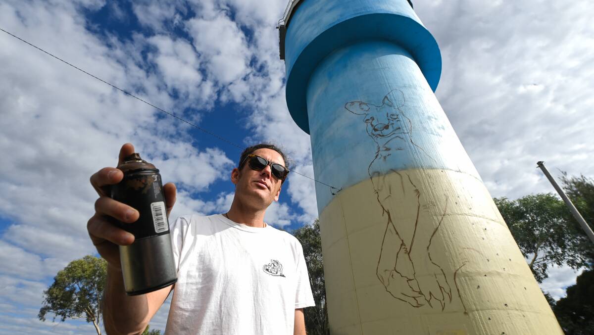 ART IN TOWN: Walla Walla's water tower in the middle of town is being painted by Wagga raised artist Damien Mitchell. Picture: MARK JESSER