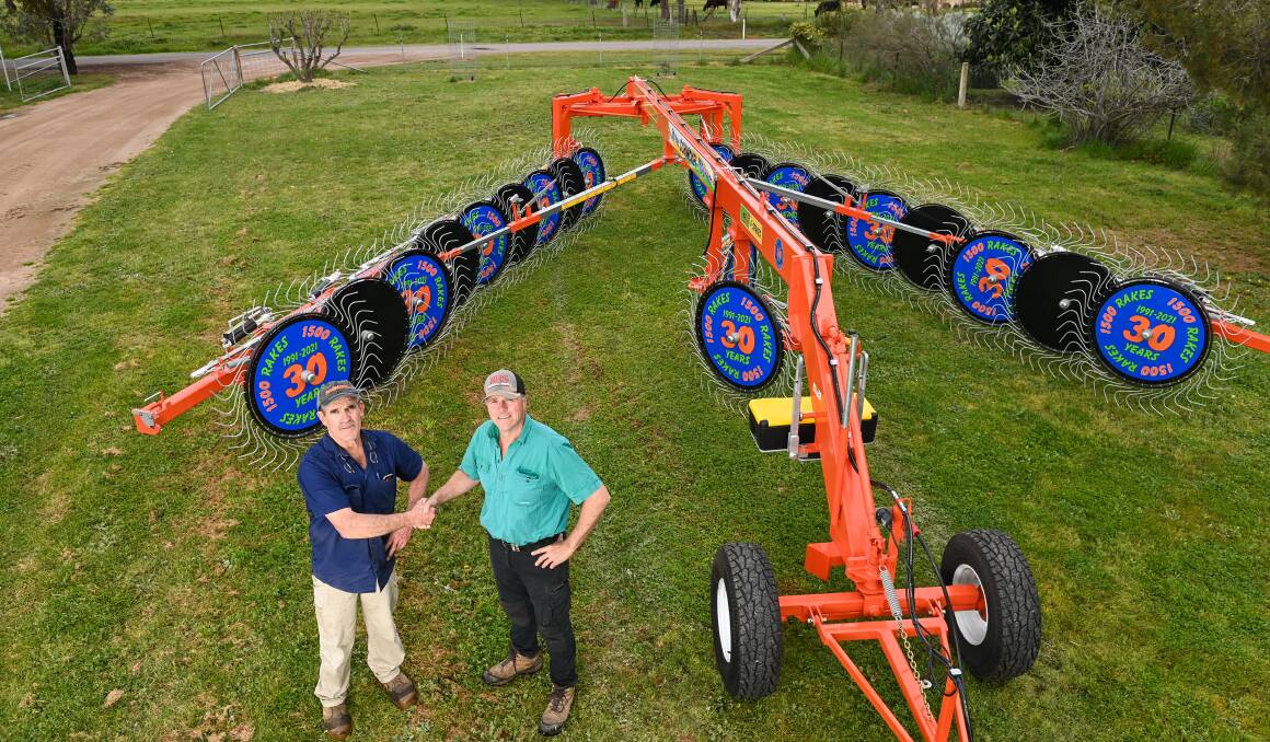CHANGING HANDS: Owner of Schinckel Hayrakes Simon Schinkel and Holbrook contractor Brett Strong. Mr Schinckel has sold his 1500th hay rake to Mr Strong. Picture: MARK JESSER