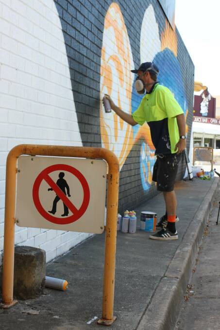 Artist Lukas Kasper at work on some of his murals around Wodonga. Pictures: SUPPLIED