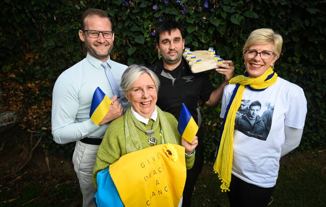 YELLOW AND BLUE: Musician Craig Quilliam, concert organiser Susan Makepeace, Locky's Countryside Meats butcher Jarryd Mercieca and Chicken Kyiv fundraiser organiser Andrea Palmer. Picture: MARK JESSER