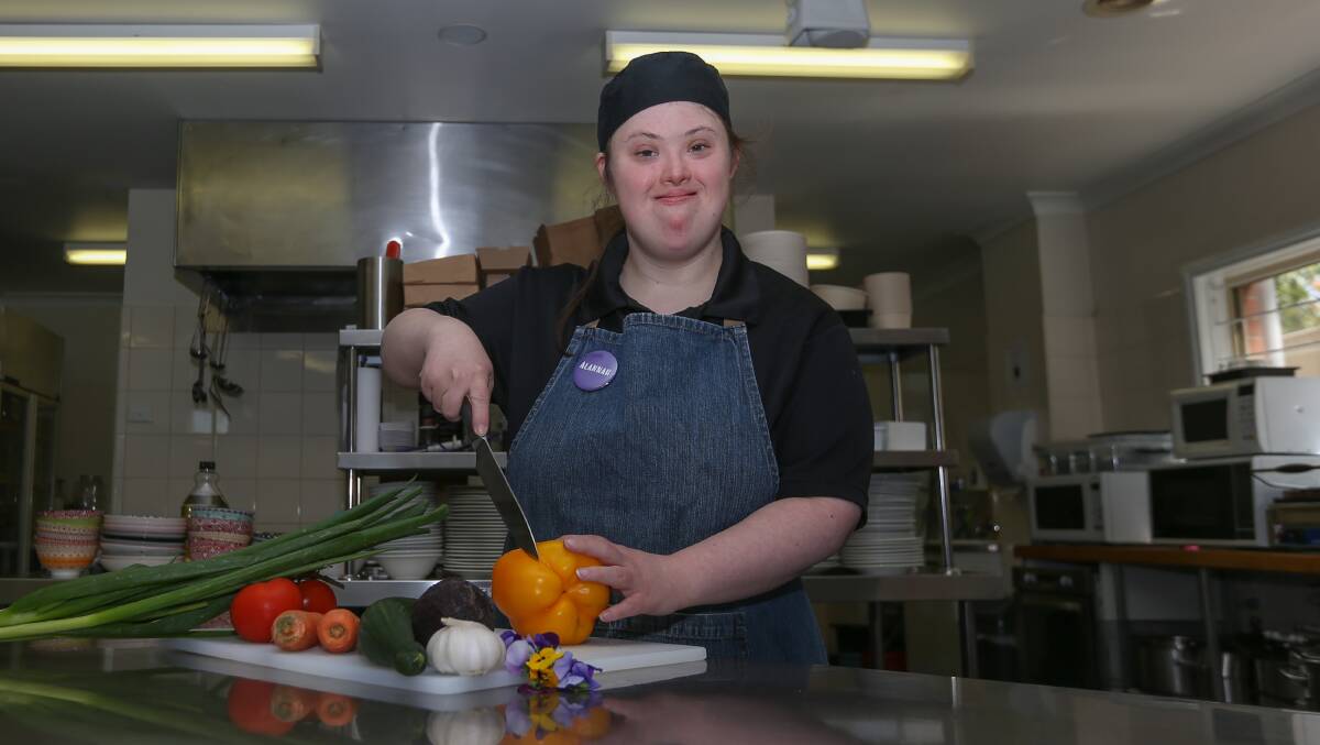 COMMUNITY CHAMPION: The Border's Alannah McKeown preparing food in the kitchen at Albury's Purple Chicken cafe. Ms McKeown was named a Victoria Future Healthy Community Champion. Picture: TARA TREWHELLA