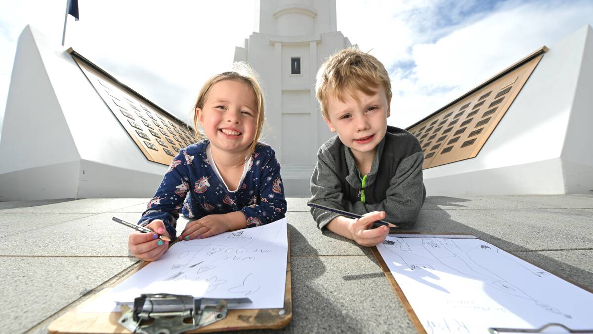 DRAWING HISTORY: Preschoolers Elodie Symons (4) and Remy Clarke (5) are drawing pictures of Monument Hill ahead of Anzac Day. Picture: MARK JESSER.