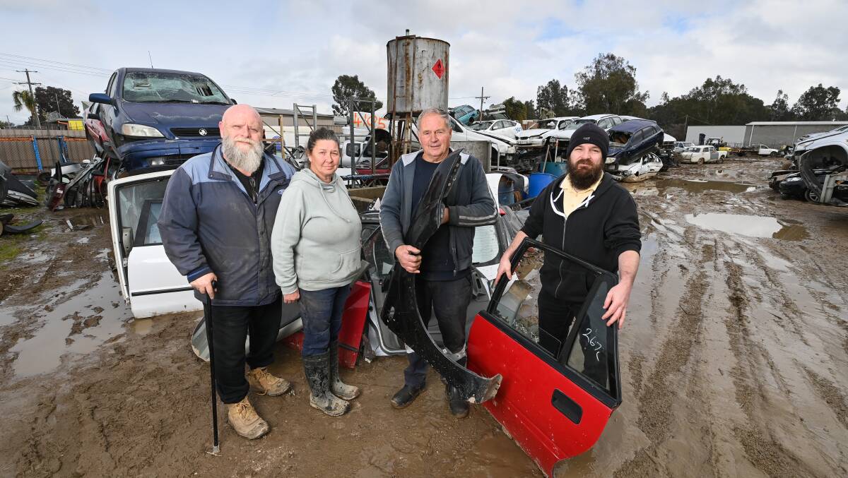 END OF AN ERA: Allan and Kim White with former mechanic Chuddy Chandler and Stephen Pyle at the Wangaratta Auto Wreckers. Picture: MARK JESSER