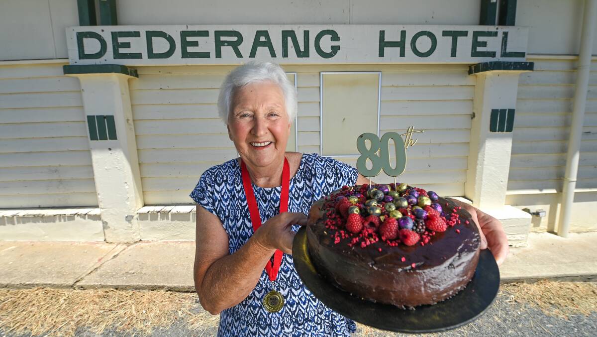 BIG SMILES: Beverley Simpson holding her and her friends' 80th birthday cake for their traditional gathering and celebration. Picture: MARK JESSER