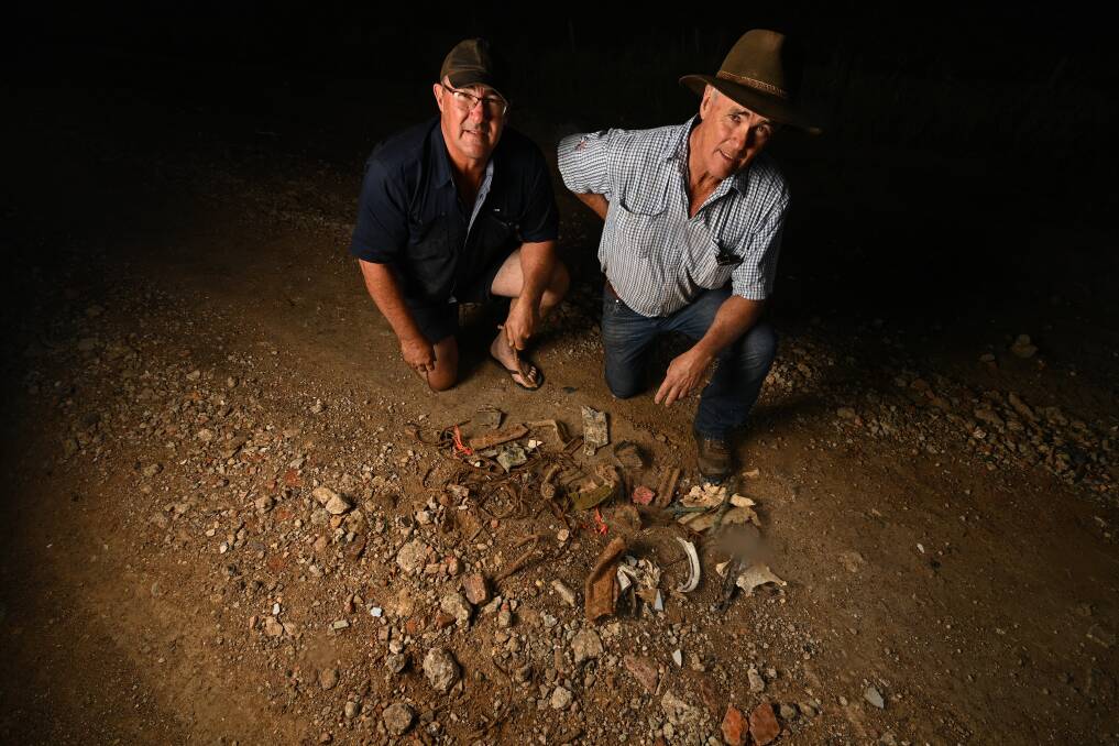 UNSAFE: Federation Council placed metal and concrete into pot holes on Patterson Rd Rennie after running out of gravel. Nearby farmers and brothers Jack and Bill Ferguson pose with the damage. Picture: MARK JESSER