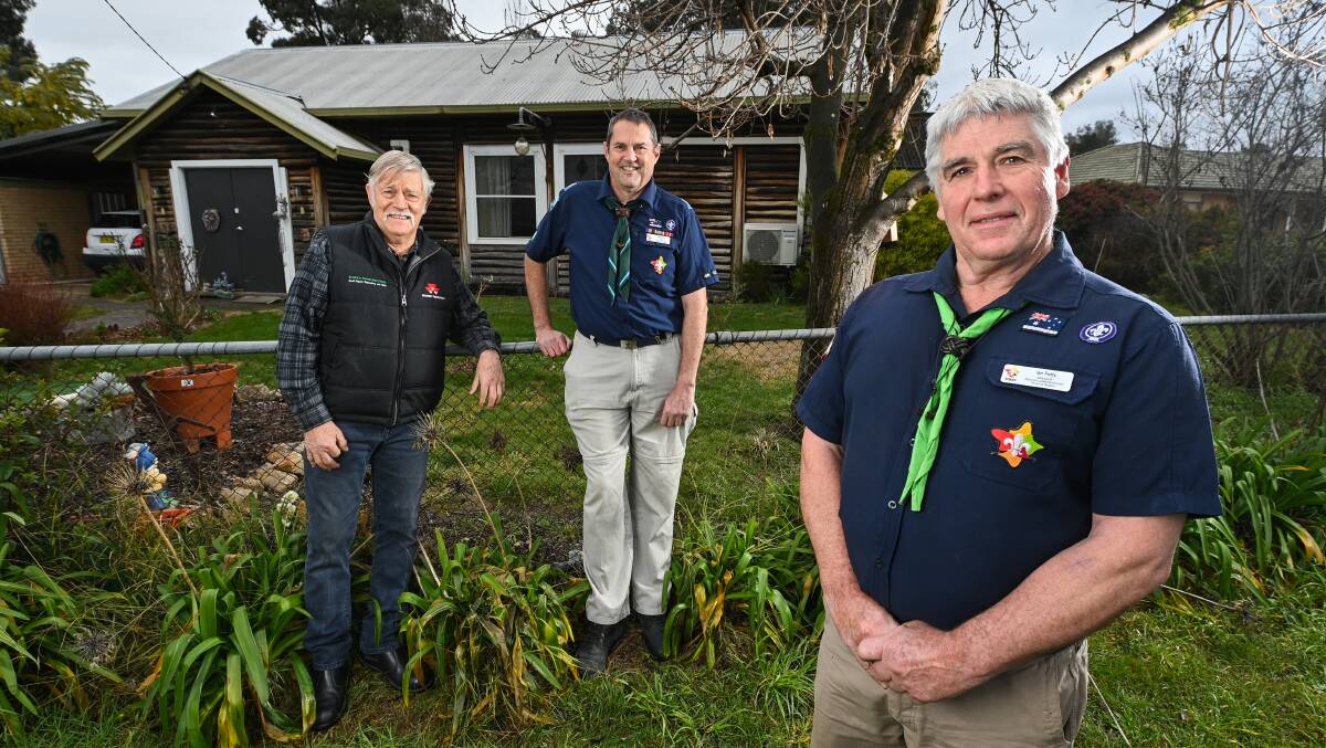 Former Holbrook scouts leader Colin Strong, Scouts NSW Ian Hall and Ian Petty in front of Holbrook's original scouts log cabin headquarters. Picture: MARK JESSER