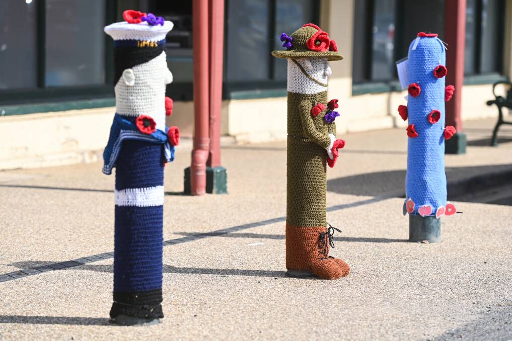 THEMED ART: Yarn bombing Anzac Day themed art on bollards in the main street of Chiltern. Pictures: MARK JESSER