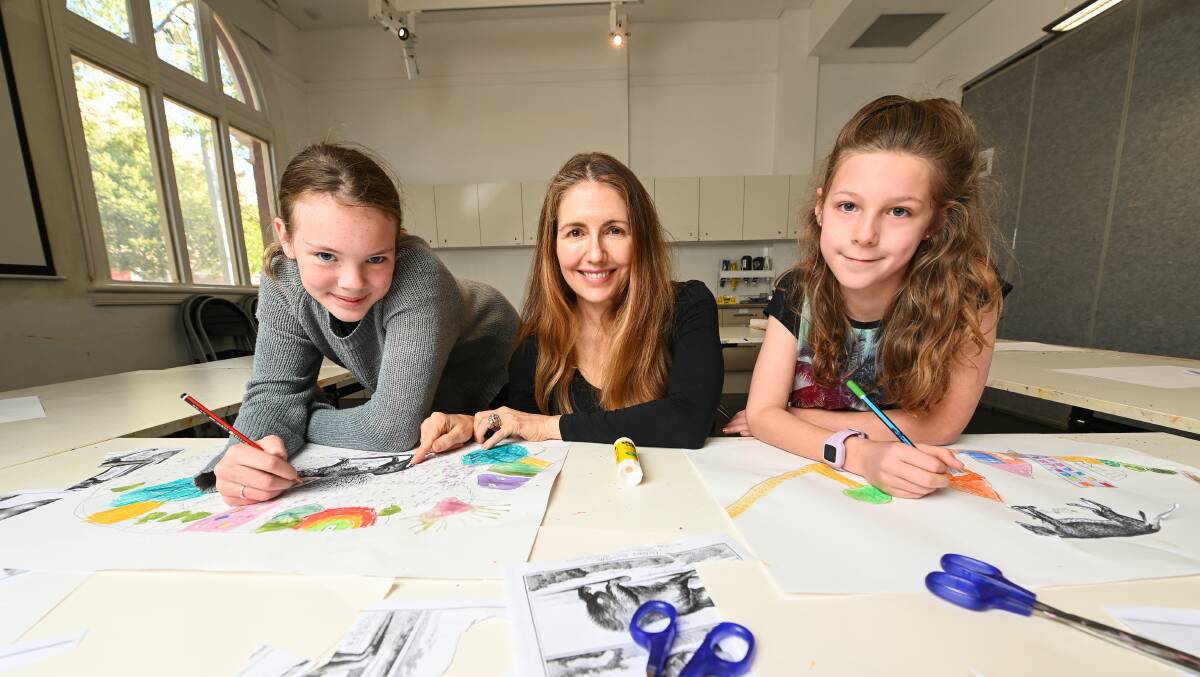 EXPLORING NATURE: Cousins Rhianna Denton (11) and Isla Lewis (9) with Skywhale artist Patricia Piccinini (middle) after an art camp workshop at MAMA on Thursday exploring themes like environment, connection and care giving. PICTURE: MARK JESSER.