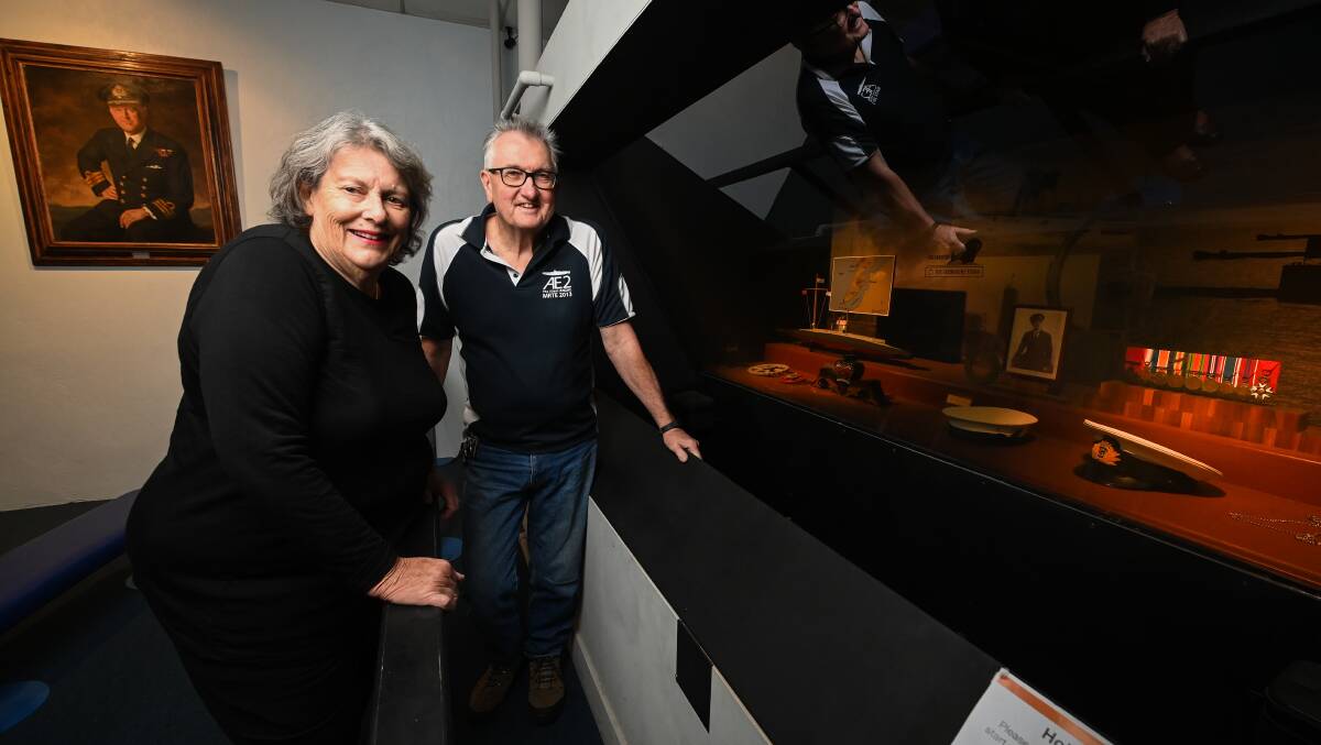 HISTORY: Greater Hume Councillor Heather Wilton with Holbrook Submarine Museum curator Morrie Jeppensen in front of a painting of Commander Holbrook and replicas of his medals. Picture: MARK JESSER