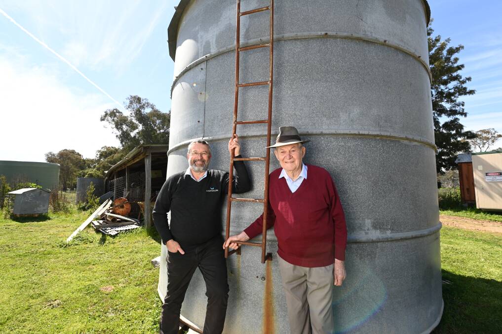 CHANGING HANDS: Walla's Andrew Kotzur and Henty's David Muller with the original Kotzur silo. Picture: MARK JESSER