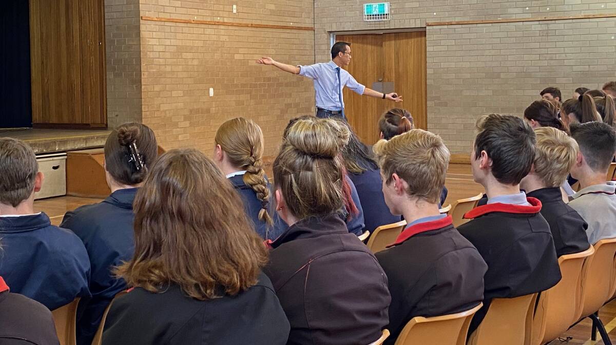 CAPTIVE AUDIENCE: Mr Woo speaking to students from Albury, Tumbarumba and Murray high schools at the Albury High School Hall.