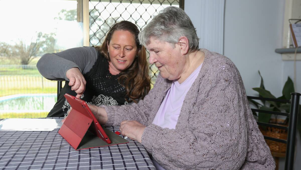 LEARNING: Holbrook's Ruth Parker teaches Gai Langford how to use the iPads. Picture: TARA TREWHELLA
