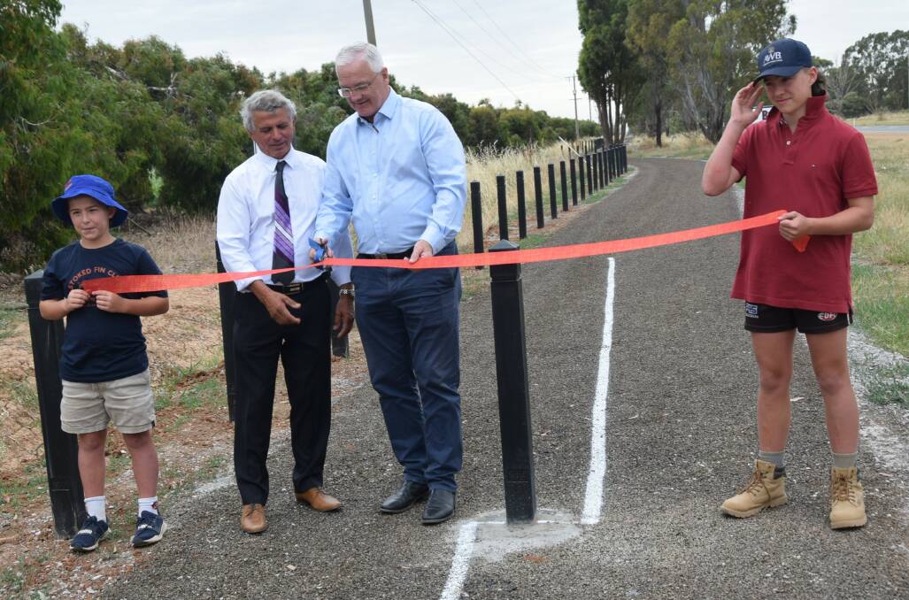 RIBBON CUTTING: Moira mayor Libro Mustica and Member for Nicholls Damian Drum opening the trail with boys Henry and Joe Kelly, the grandsons of Leo Kelly who donated land to complete the Adventure Trail. Picture: SUPPLIED