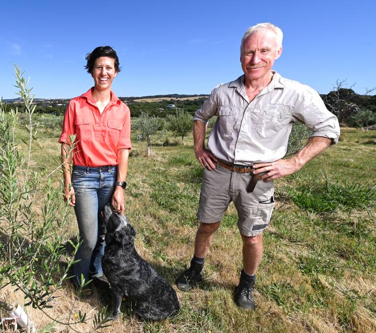HELP NEEDED: Beechworth farmers Gamila MacRury and Mark Walpole with dog, Liz. Pictures: MARK JESSER