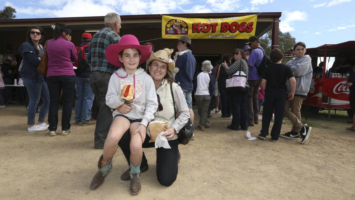 HUNGRY: Visitors to the 2022 Henty Machinery Field Days might have to feast on something other than hot chips this year. Pictured: Carmel Sorraghan and daughter Ashlee Magnusson, then 9, enjoying a hot dog at Henty Field Days in 2019.