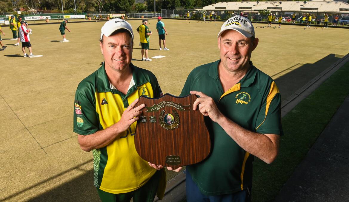 IN MEMORY: North Albury Bowling Club vice-president Stephen Broad and president Steve Martini with the trophy for Salty's Tournament. Picture: MARK JESSER