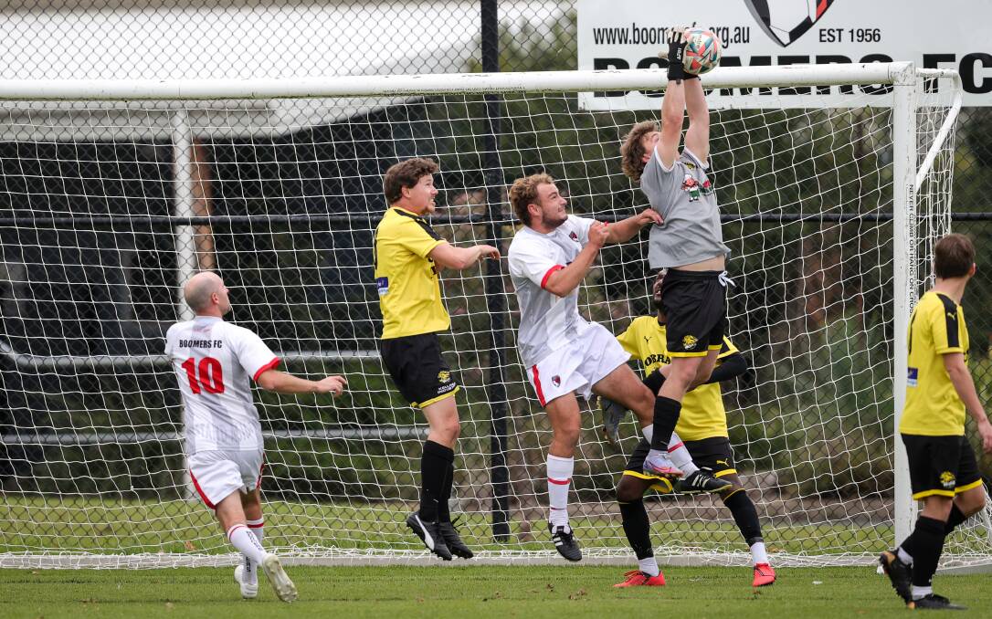 MY BALL: Cobram keeper Tarykn Hyde gets up well to gather this cross with Joel McKimmie and Andrew Grove (10) lurking. Picture: JAMES WILTSHIRE