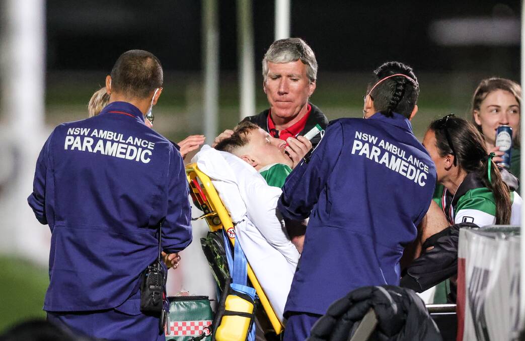 Paramedics attend to Ben Hughes with AWFA president Greg Scott also on hand. Picture by James Wiltshire