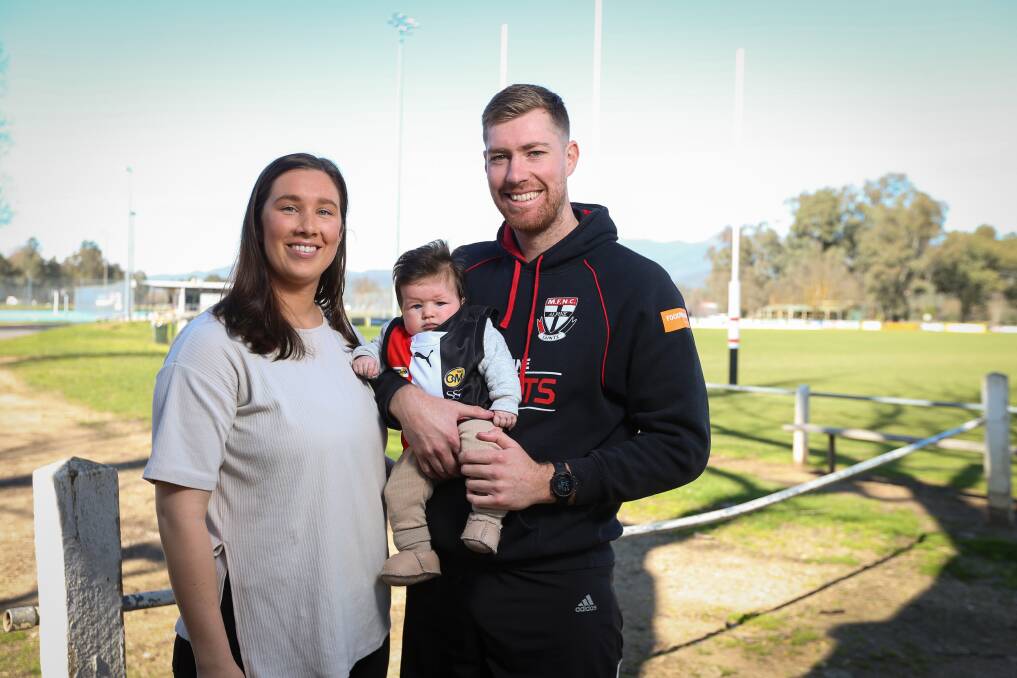 BABY SAINT: Myrtleford co-coach Jake Sharp with his partner, Emma Botter, and their three-month-old daughter, Wila. Picture: JAMES WILTSHIRE