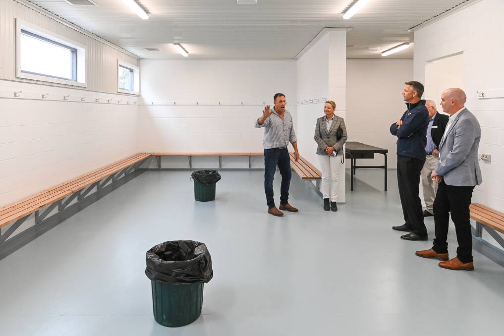 GUIDED TOUR: Russell Parker shows some of the guests around the new change rooms at Friday's event.