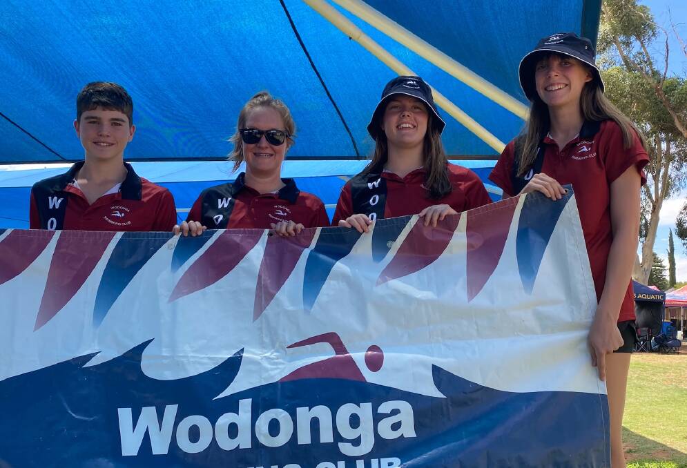 LIFE IN THE FAST LANE: Wodonga swimmers James Tinkler, Lucy Elderfield and Abbey Freeman with coach Charlie Lovell at the Victorian Country Championships in Mildura.