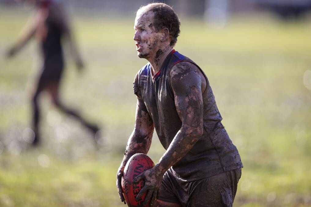 A mud-spattered Brayden Carey takes aim for Beechworth. Picture by James Wiltshire
