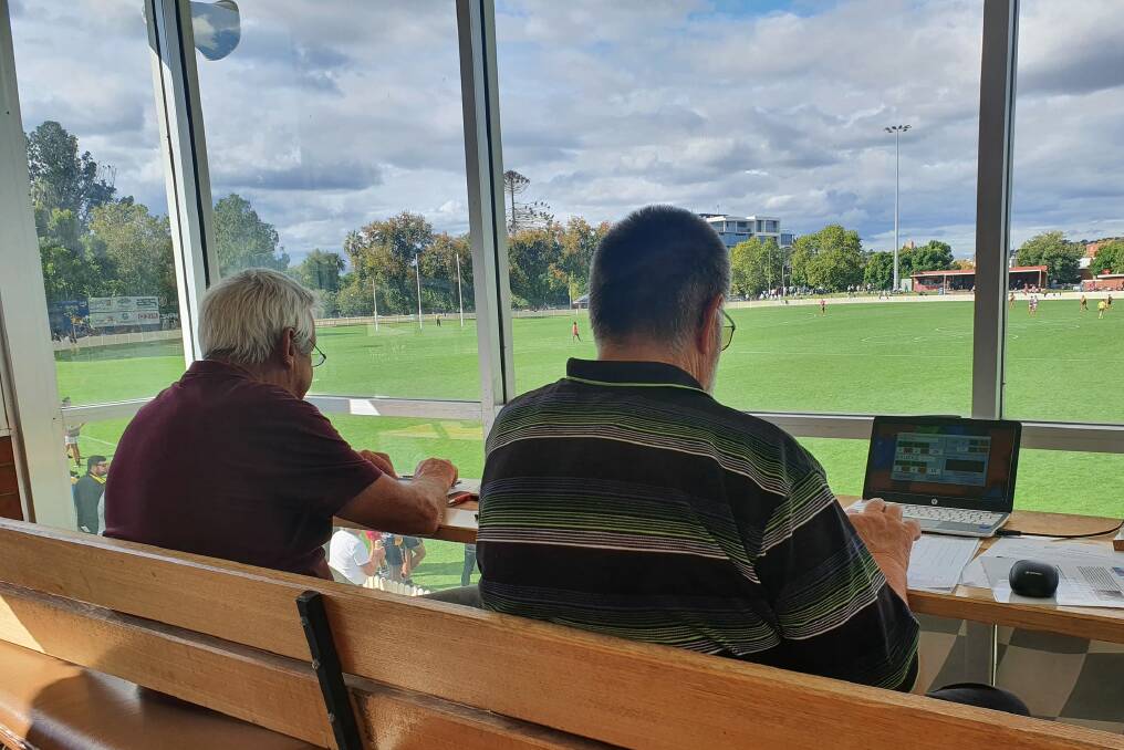 Tom Rollings (right) in the timekeeper's box at the Sportsground.