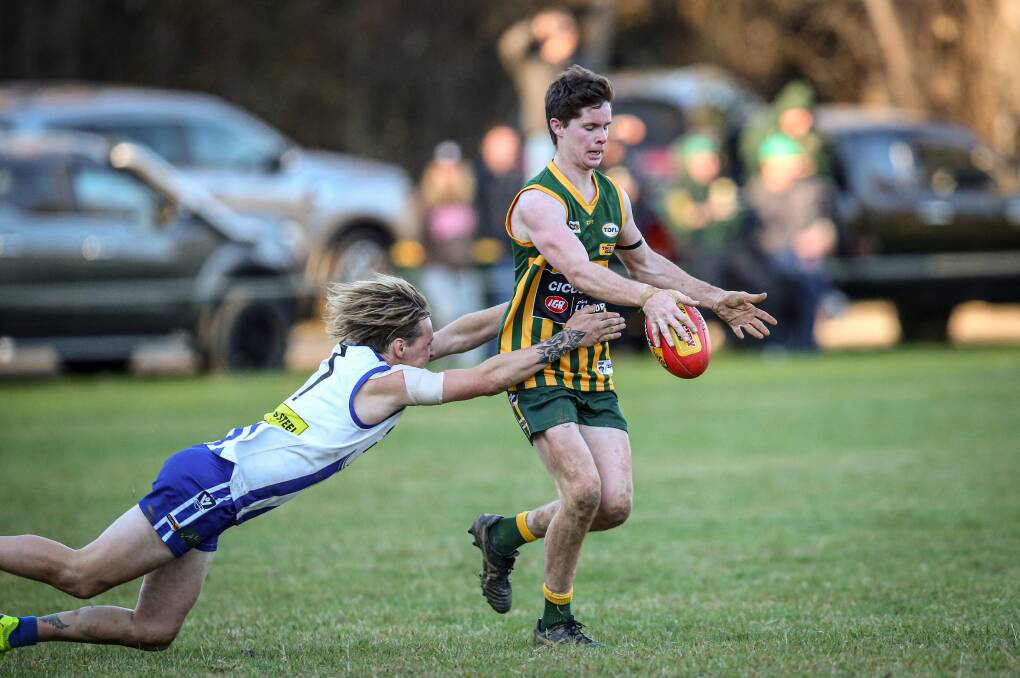 Daniel O'Connell gets his kick away for Tallangatta despite the attentions of Yackandandah's Chad Martin. Picture: JAMES WILTSHIRE