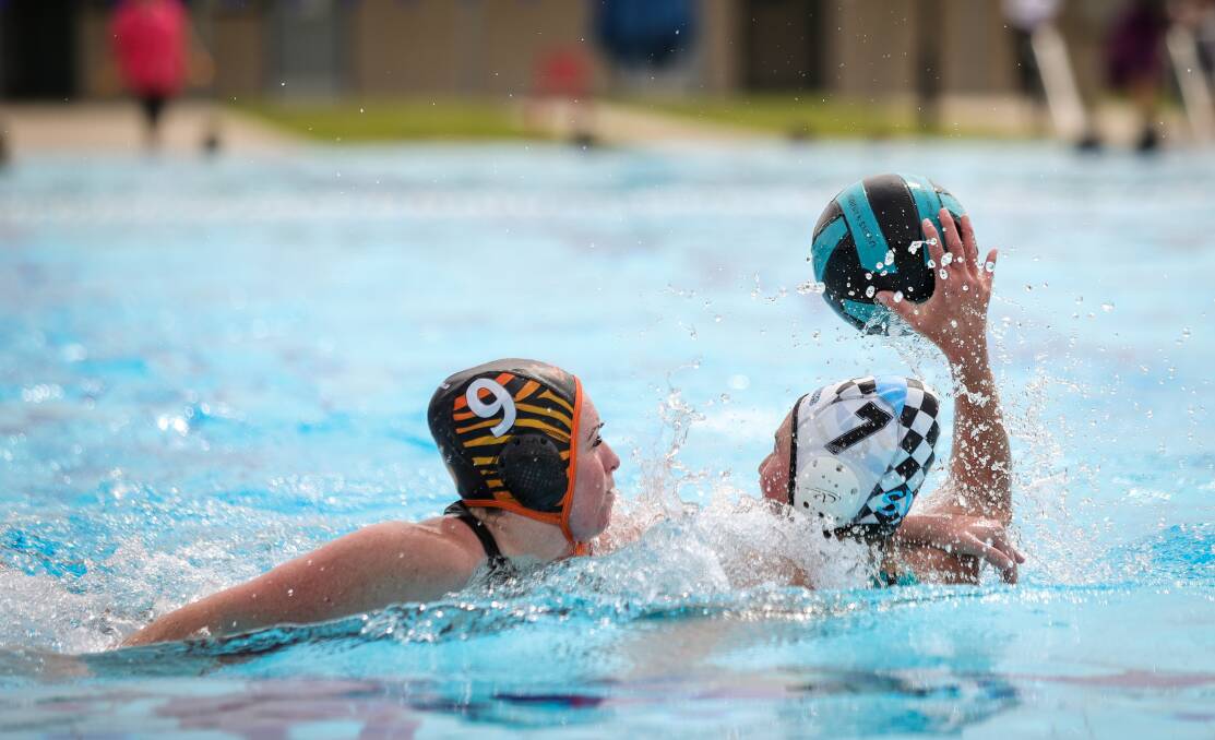 Six-goal Jodie Millett looks for a Sharks team-mate under pressure from Albury Tigers' Catherine Pratt during the round one clash at WAVES. Picture by James Wiltshire